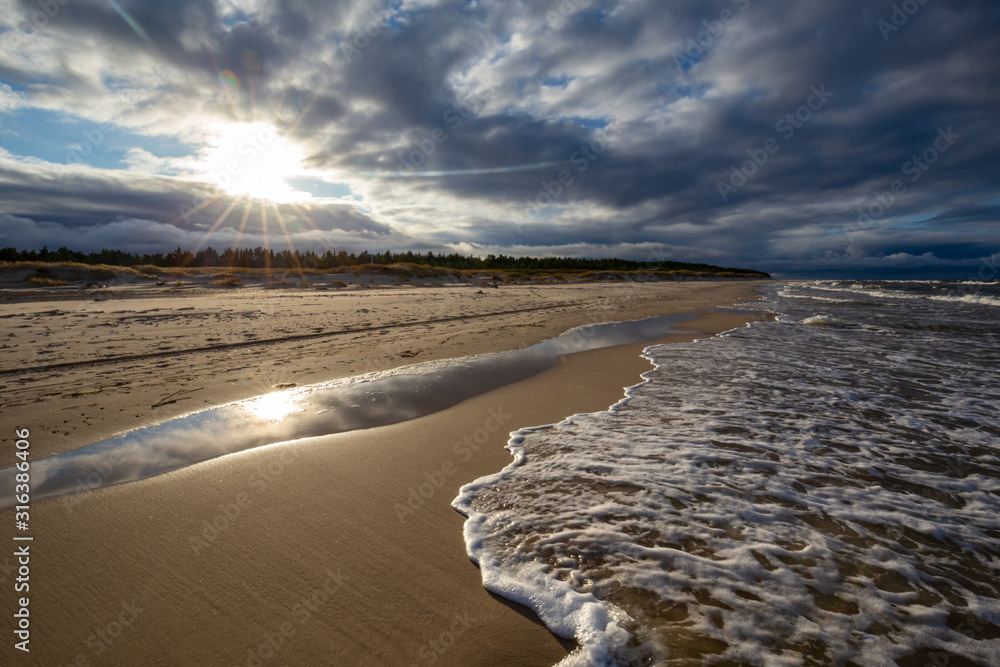 A beach after a storm during a windy evening in the Slowinski National Park. Czolpino, Leba, Poland.