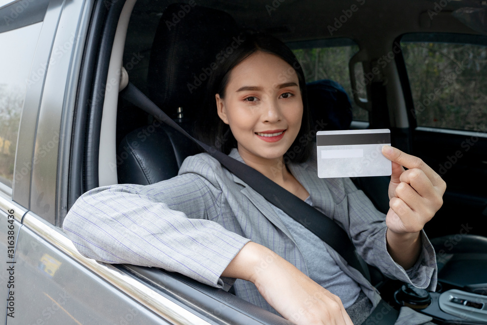 Chinese Thai Asian Woman showing her blank driving license  while in the car
