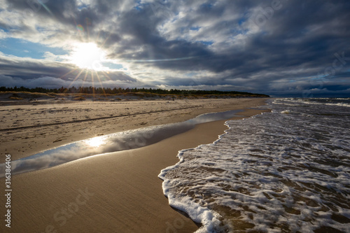 Obraz na płótnie A beach after a storm during a windy evening in the Slowinski National Park. Czolpino, Leba, Poland. w salonie