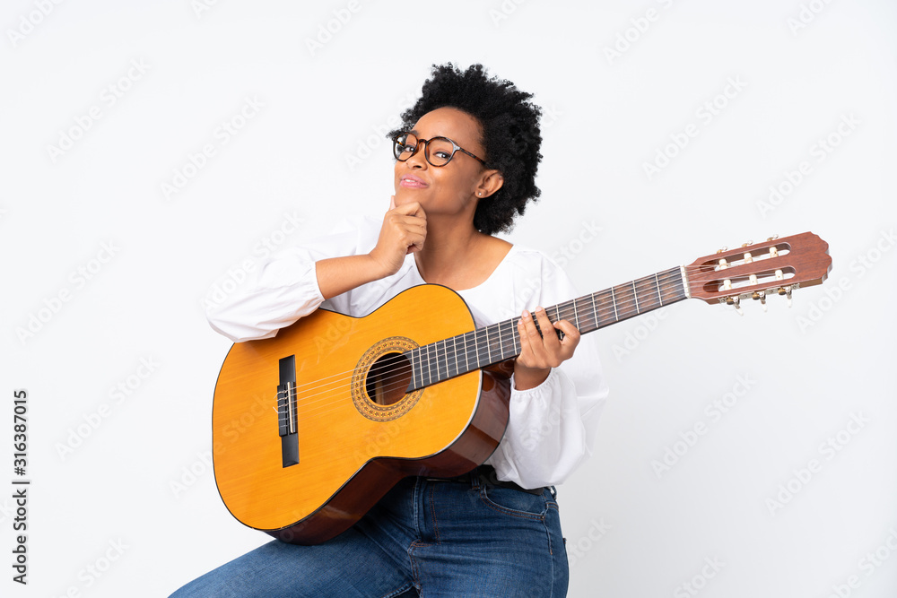African american woman with guitar over isolated background looking side African american woman with guitar over isolated background looking side