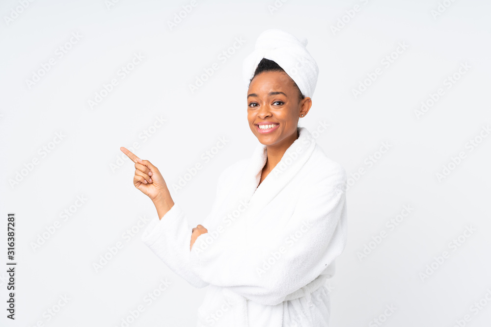 African american woman in a bathrobe over isolated background pointing finger to the side African american woman in a bathrobe over isolated background pointing finger to the side