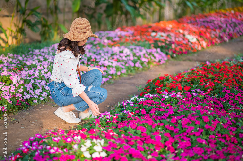 Young woman take a photo in the flowers garden Young woman take a photo in the flowers garden