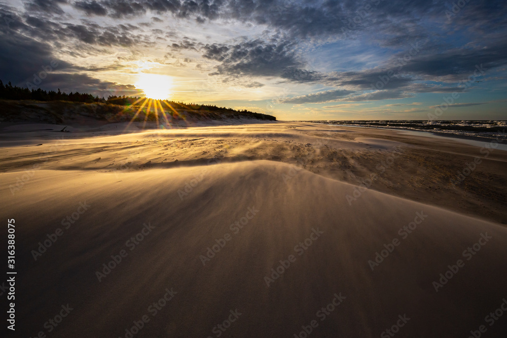 A beach after a storm during a windy evening in the Slowinski National Park. Czolpino, Leba, Poland.