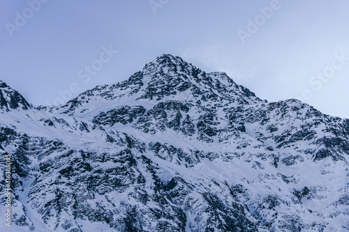 Snowy mountains during a sunny winter day in the alps  near the village of Sankt Moritz and Silvaplana  Switzerland - January 2020