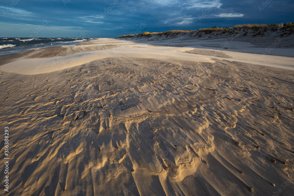 A beach after a storm during a windy evening in the Slowinski National Park. Czolpino, Leba, Poland.