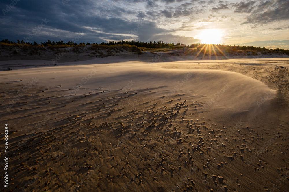 A beach after a storm during a windy evening in the Slowinski National Park. Czolpino, Leba, Poland.