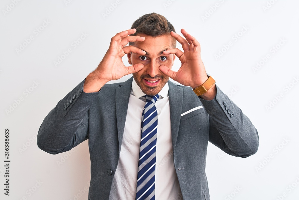 Young handsome business man wearing suit and tie over isolated background Trying to open eyes with fingers, sleepy and tired for morning fatigue Young handsome business man wearing suit and tie over isolated background Trying to open eyes with fingers, sleepy and tired for morning fatigue