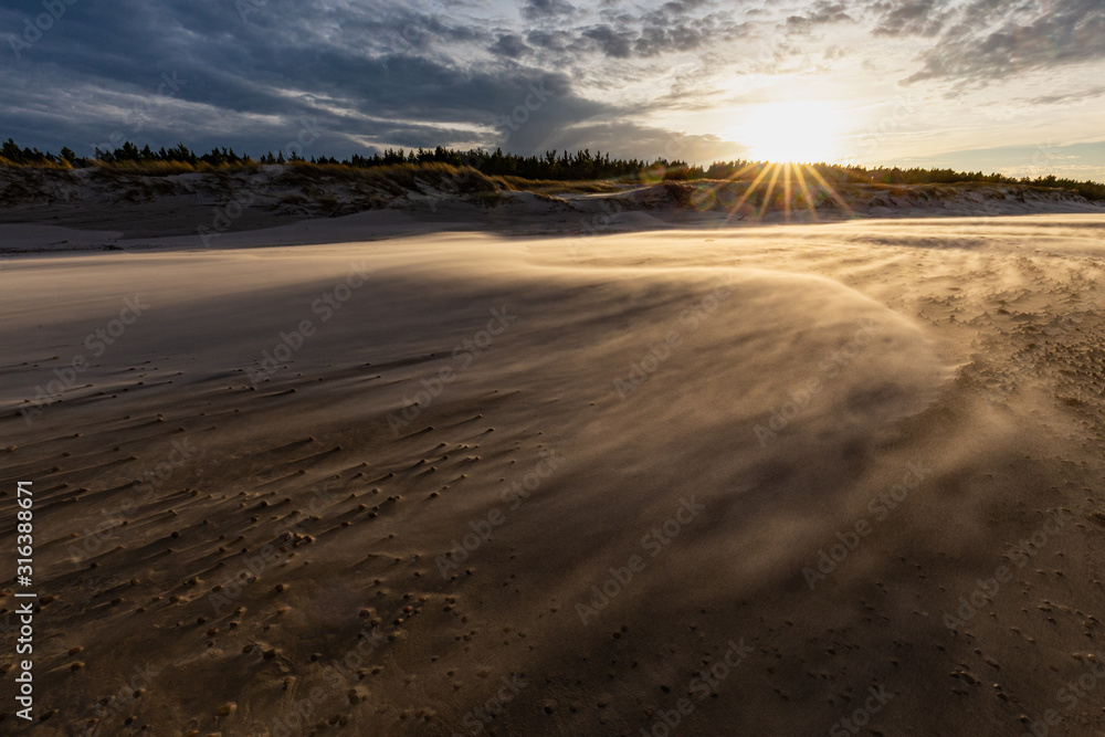 A beach after a storm during a windy evening in the Slowinski National Park. Czolpino, Leba, Poland.