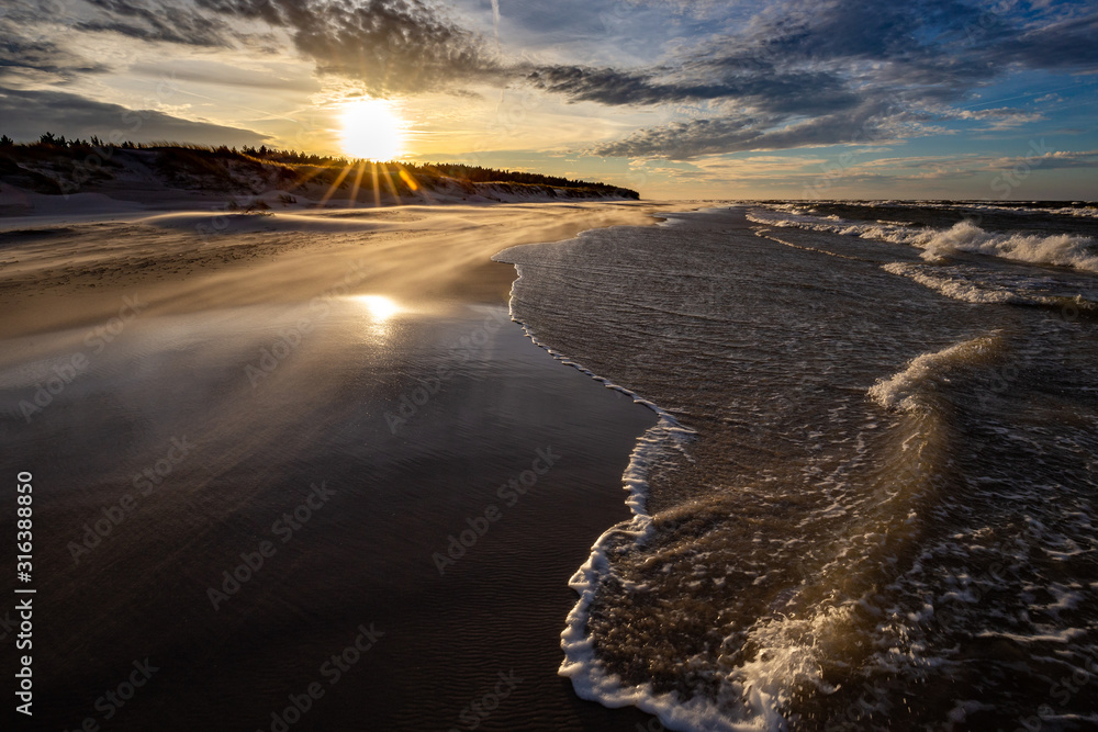 A beach after a storm during a windy evening in the Slowinski National Park. Czolpino, Leba, Poland.