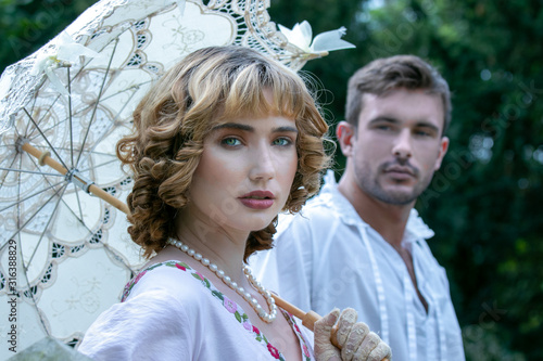 Cuadro en lienzo Handsome young couple in vintage clothing with beautiful lady looking at camera