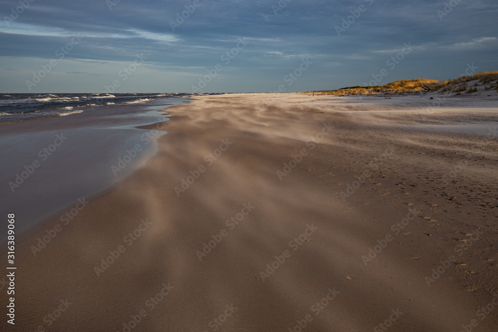A beach after a storm during a windy evening in the Slowinski National Park. Czolpino, Leba, Poland.