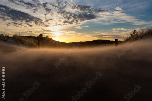 Obraz na płótnie Dunes during a windy evening in the Slowinski National Park. Czolpino, Leba, Poland. w salonie