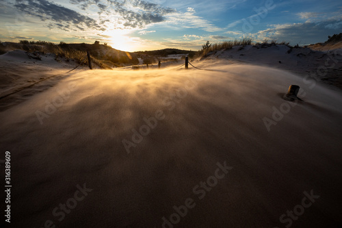 Obraz na płótnie Dunes during a windy evening in the Slowinski National Park. Czolpino, Leba, Poland. w salonie