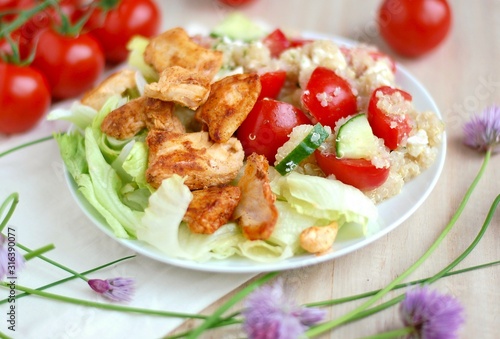 Quinoa salad with chicken fillets, lettuce, tomato, cucumber and chives