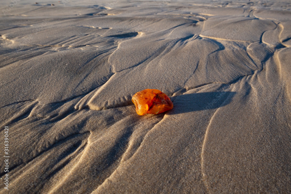 Amber on the beach in the Slowinski National Park. Czolpino, Leba, Poland.