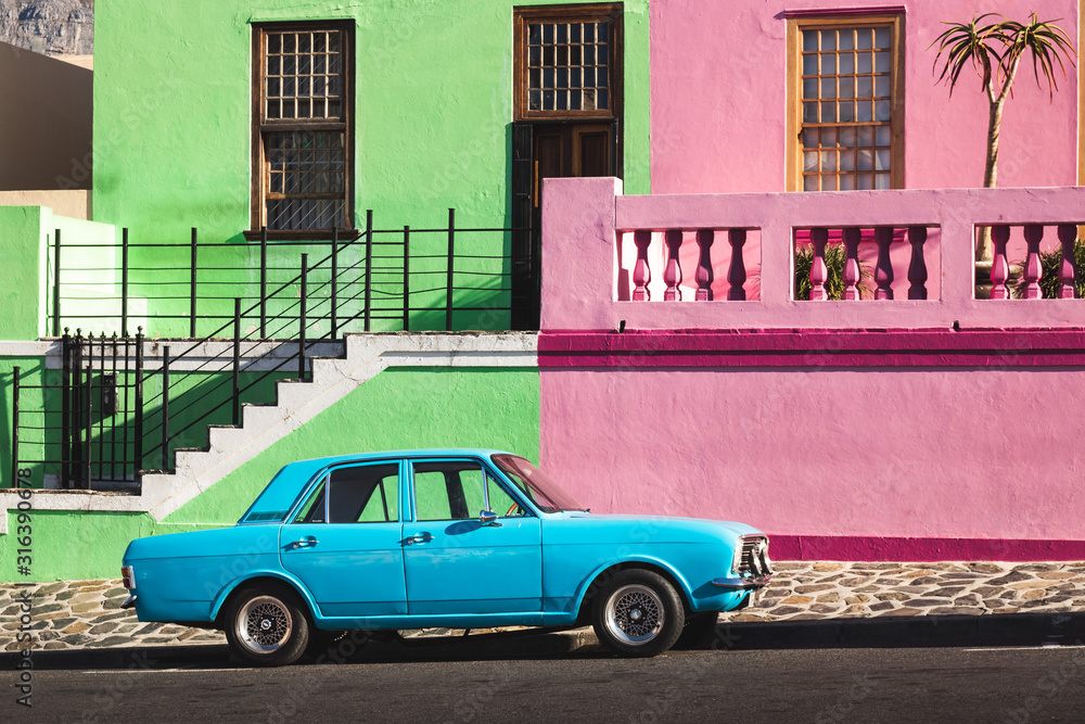 Old blue car in front of colorful houses, Bo-Kaap, Capetown Old blue car in front of colorful houses, Bo-Kaap, Capetown