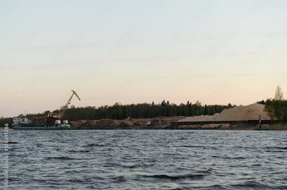 Evening loading of the forest on the Sheksna River. Vologda Region