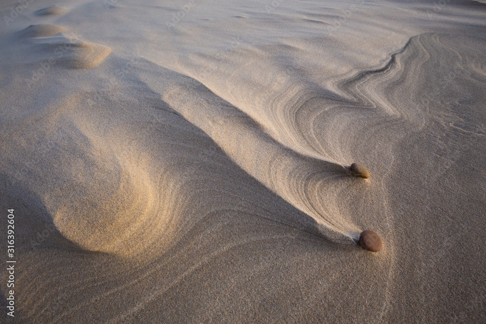 Beautiful patterns created by the wind on the beach in the Slowinski National Park. Czolpino, Leba, Poland.