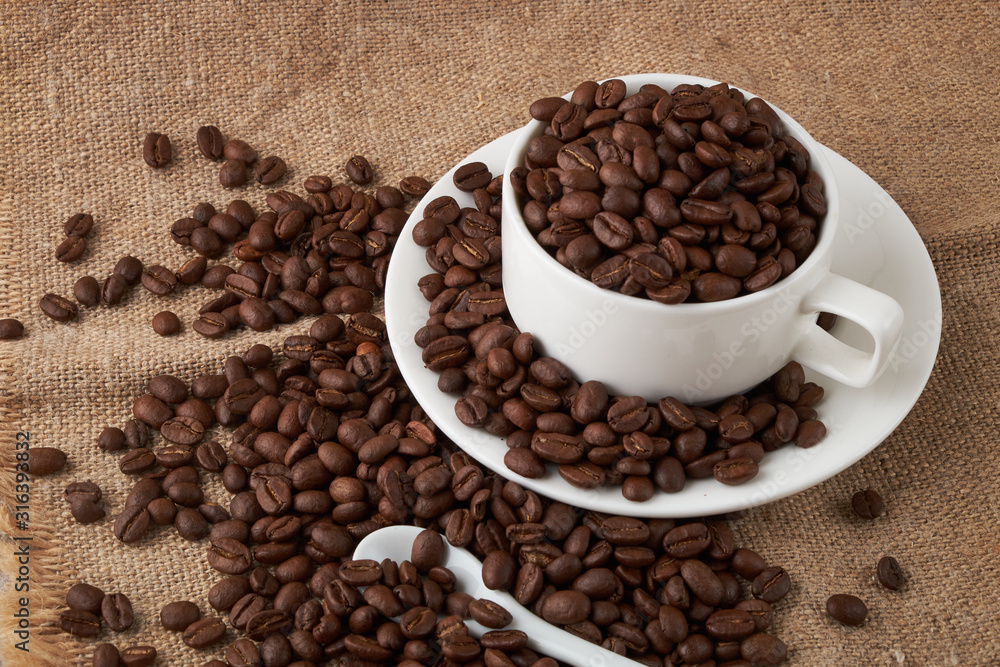 Coffee Cup and coffee beans on the table close-up Coffee Cup and coffee beans on the table close-up