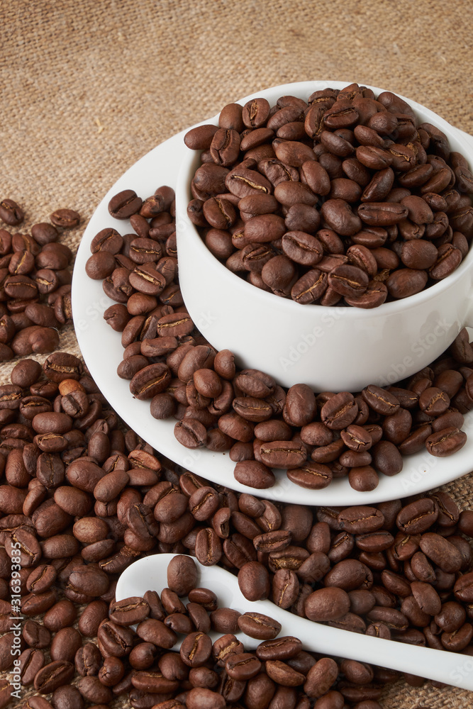 Coffee Cup and coffee beans on the table close-up Coffee Cup and coffee beans on the table close-up