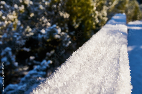 snow covered railing at Jezerni Slat near Kvilda on a sunny day 