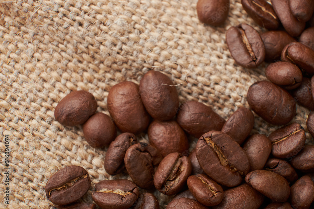 Fototapeta premium Coffee Cup and coffee beans on the table close-up