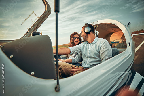 Slika na platnu Couple in love in a small private airplane