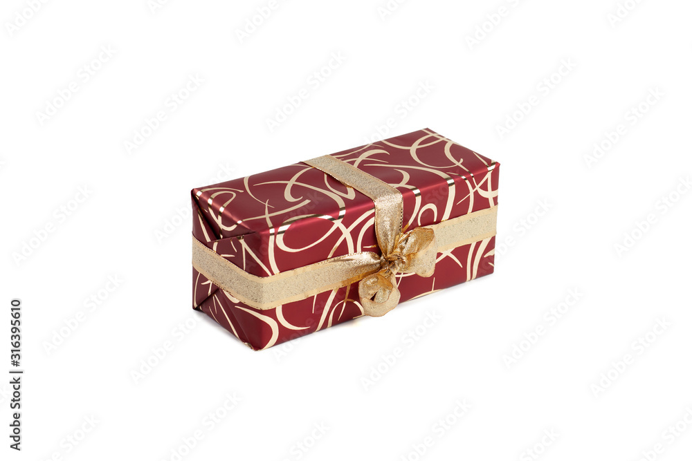 packaged rectangular gift in burgundy packaging with gold bow and gold pattern on the white background packaged rectangular gift in burgundy packaging with gold bow and gold pattern on the white background