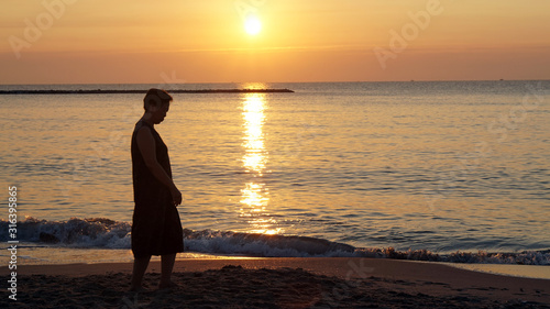 Asian elder woman silhouette at beach happy found purpose of life