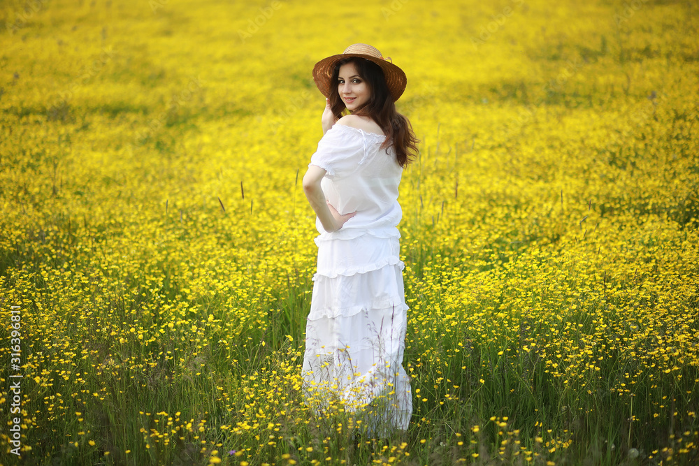 Pregnant woman in a dress in a field of flowers Pregnant woman in a dress in a field of flowers