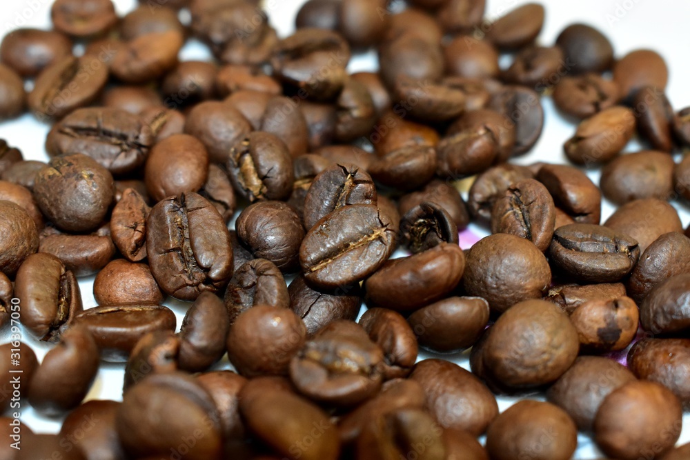 Fototapeta premium Roasted coffee beans on a substrate.