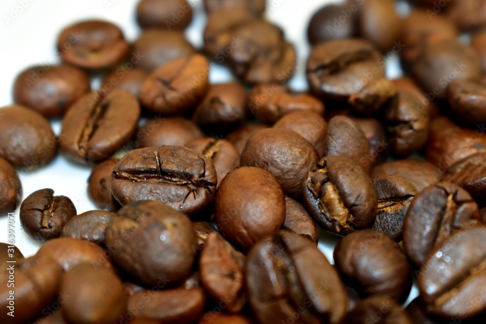 Roasted coffee beans on a substrate. Roasted coffee beans on a substrate.
