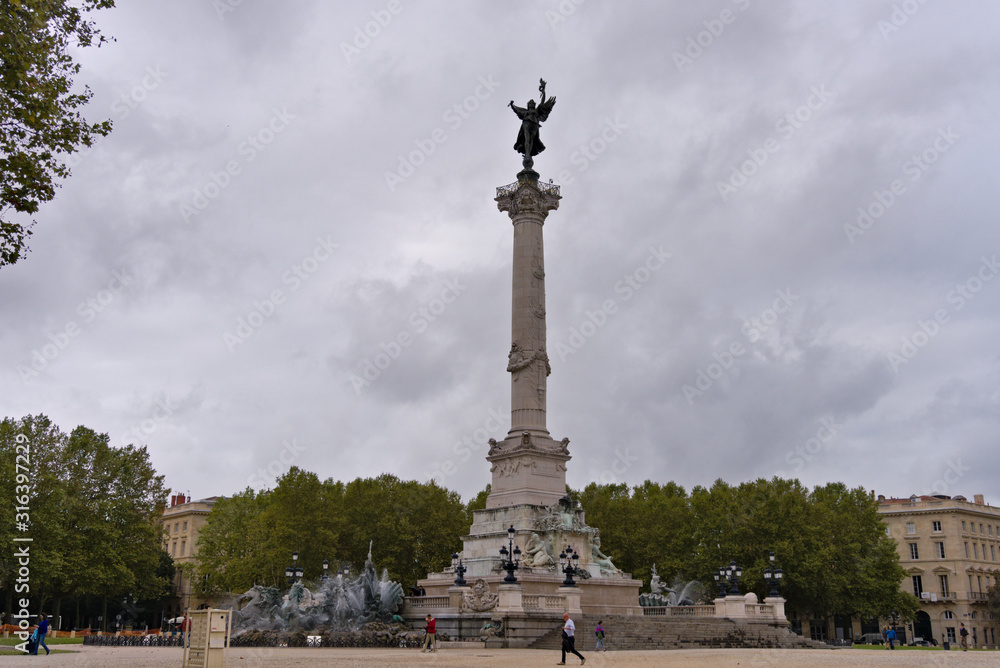 Far away view on the Monument aux Girondins on the Quinconces Square in Bordeaux, France, with cloudy, rainy sky