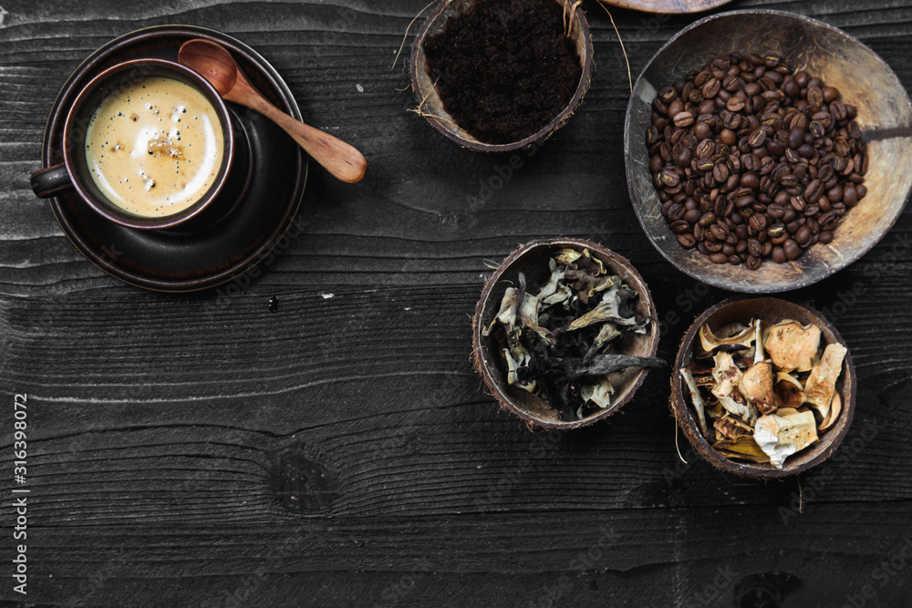 Coffee Superfood Trend, birch mushroom chaga, lion's mane mushroom, monkey head mushroom, Cordyceps, dry and fresh mushrooms and coffee beans on dark background Coffee Superfood Trend, birch mushroom chaga, lion's mane mushroom, monkey head mushroom, Cordyceps, dry and fresh mushrooms and coffee beans on dark background