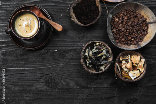 Coffee Superfood Trend, birch mushroom chaga, lion's mane mushroom, monkey head mushroom, Cordyceps, dry and fresh mushrooms and coffee beans on dark background