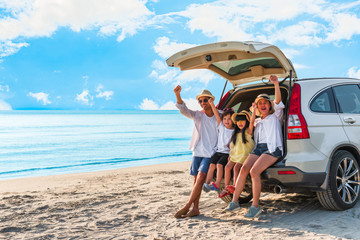 Happy asian family at consisting father, mother, son and daughter having fun in summer vacation on the beach