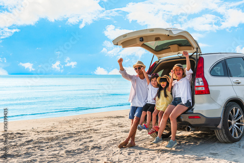 Happy asian family at consisting father, mother, son and daughter having fun in summer vacation on the beach