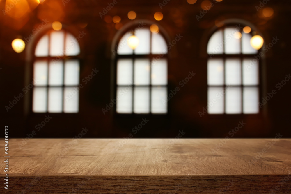 image of wooden table in front of abstract blurred window light background image of wooden table in front of abstract blurred window light background