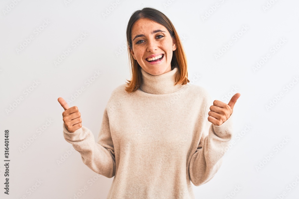 Beautiful redhead woman wearing winter turtleneck sweater over isolated background success sign doing positive gesture with hand, thumbs up smiling and happy. Cheerful expression and winner gesture. Beautiful redhead woman wearing winter turtleneck sweater over isolated background success sign doing positive gesture with hand, thumbs up smiling and happy. Cheerful expression and winner gesture.