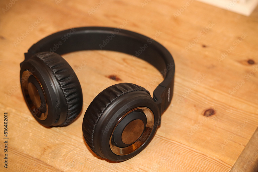Black stereo headphones on a table Black stereo headphones on a table