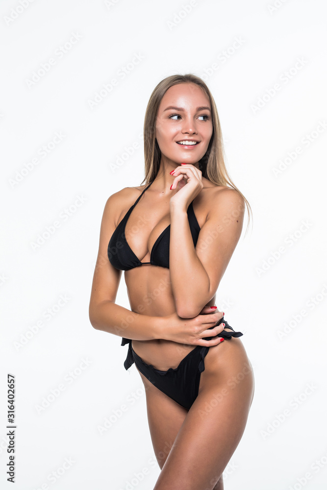Young woman posing in a black bikini isolated on white background - obrazy, fototapety, plakaty 