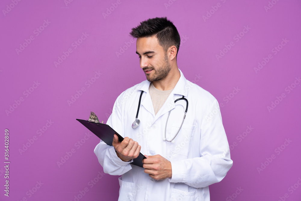 Young man wearing a doctor gown and holding a folder Young man wearing a doctor gown and holding a folder