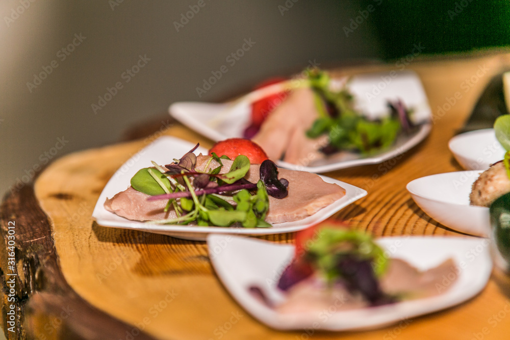 Detail of a canapes of a meal at an event, wedding, meeting or congress with food. Canapes decorated on the dish Detail of a canapes of a meal at an event, wedding, meeting or congress with food. Canapes decorated on the dish