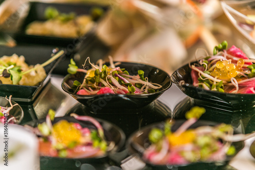 Detail of a canapes of a meal at an event, wedding, meeting or congress with food. Canapes decorated on the dish