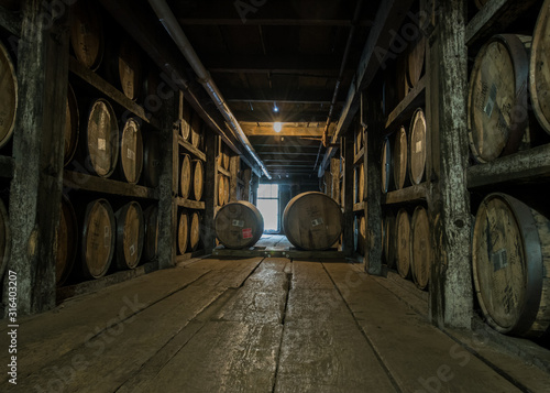 Fotografia Walking Down Barrel Storage in Distillery