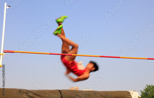 men high jump athletes in the playground