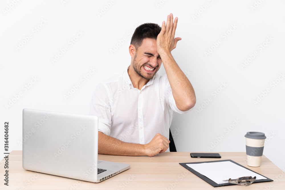 Young business man with a mobile phone in a workplace having doubts with confuse face expression Young business man with a mobile phone in a workplace having doubts with confuse face expression