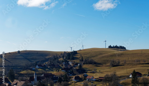 Das Dorf Gerbach im Berg (südschwarzwald), seine Evangelische Kirche, Hohle Eiche und Öschgraben mit Windkraftanlagen im Winter ohne Schnee, gesehen vom panoramaweg entlang des Rohrenkopfes photo