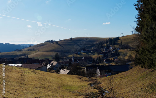 Das Dorf Gerbach im Berg (südschwarzwald), seine Evangelische Kirche, Hohle Eiche und Öschgraben mit Windkraftanlagen im Winter ohne Schnee, gesehen vom panoramaweg entlang des Rohrenkopfes photo