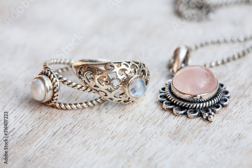 Silver jewelry on neutral bright wooden background